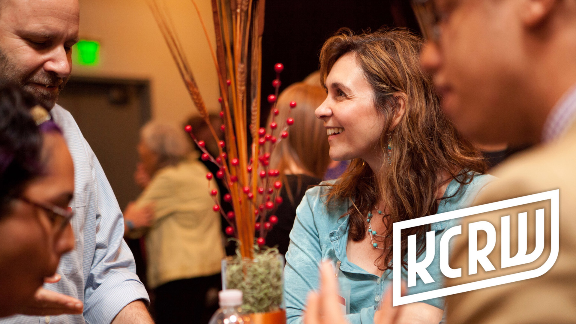 Patrons engaged in conversation during a reception.  