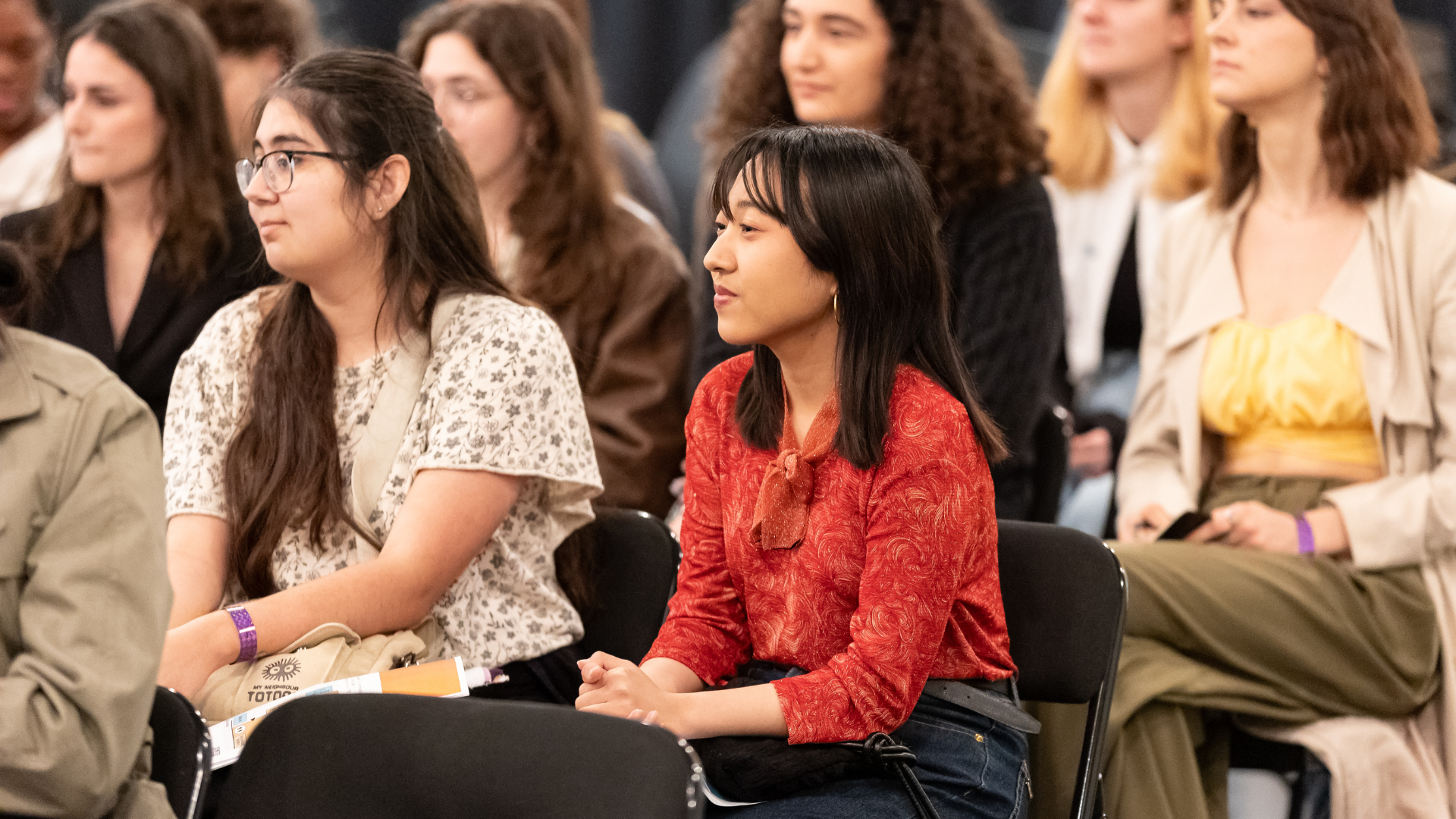 Group of participants sit engaged. 